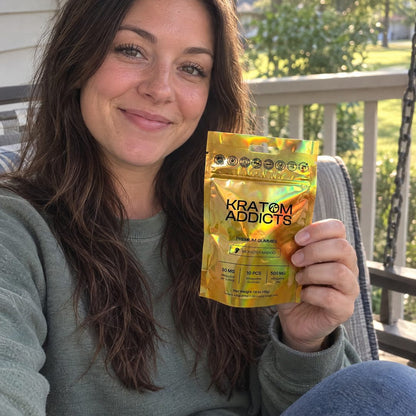 A woman on a porch swing holding Monster Mango kratom gummies
