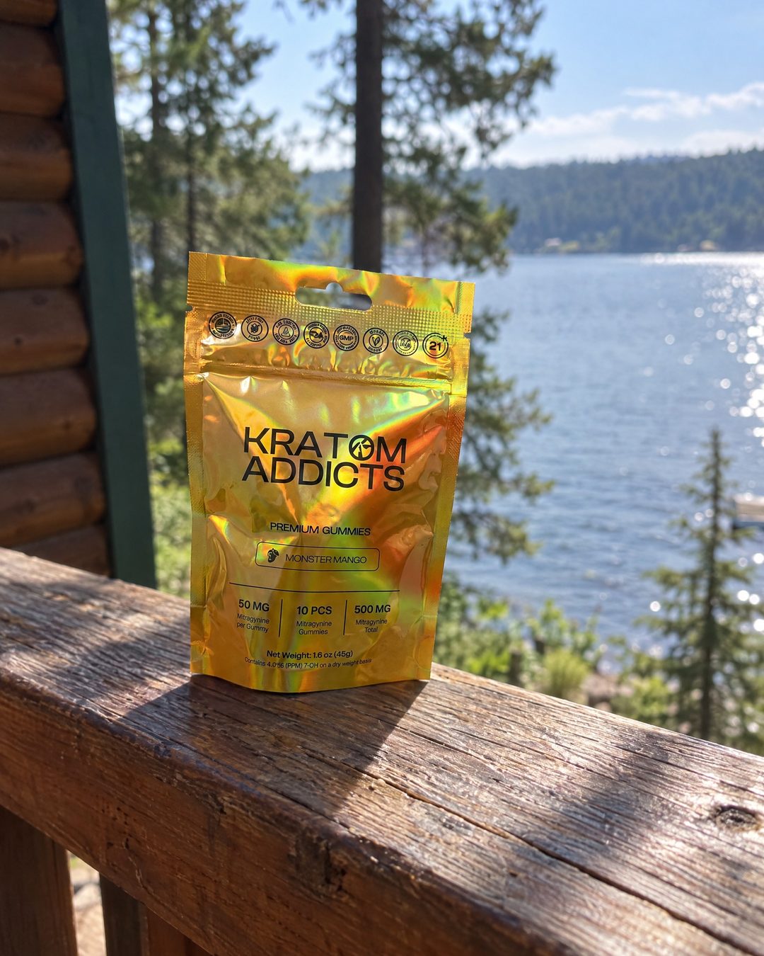 Monster Mango kratom gummies on a cabin deck above a lake