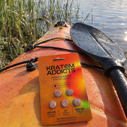 Monster Mango kratom tablets on a kayak by the water