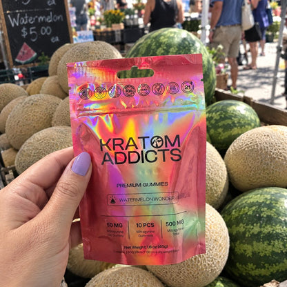 A hand holding Watermelon Wonder kratom gummies at a market stall