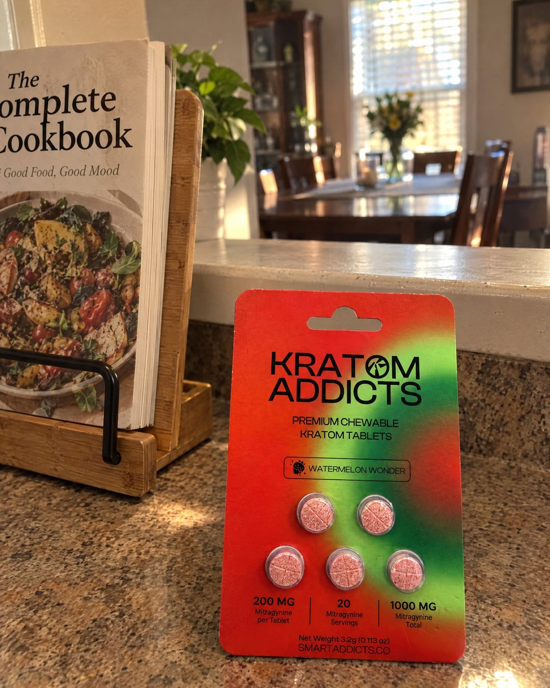 Watermelon Wonder kratom tablets on a kitchen counter beside an open cookbook